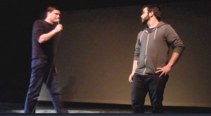 Advancing on the audience volunteer.